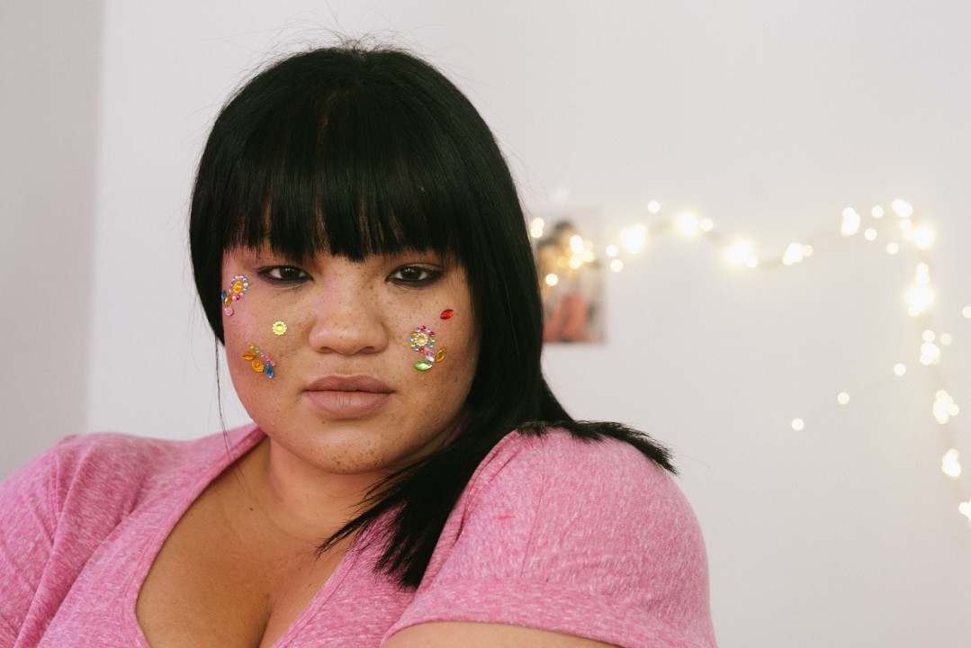 black lady facing camera with gems on her cheeks